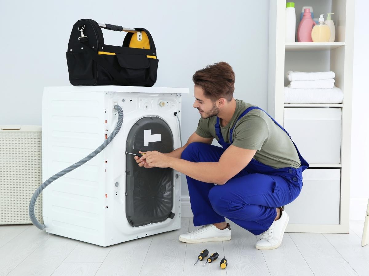 Repairman Repairing Broken Dryer